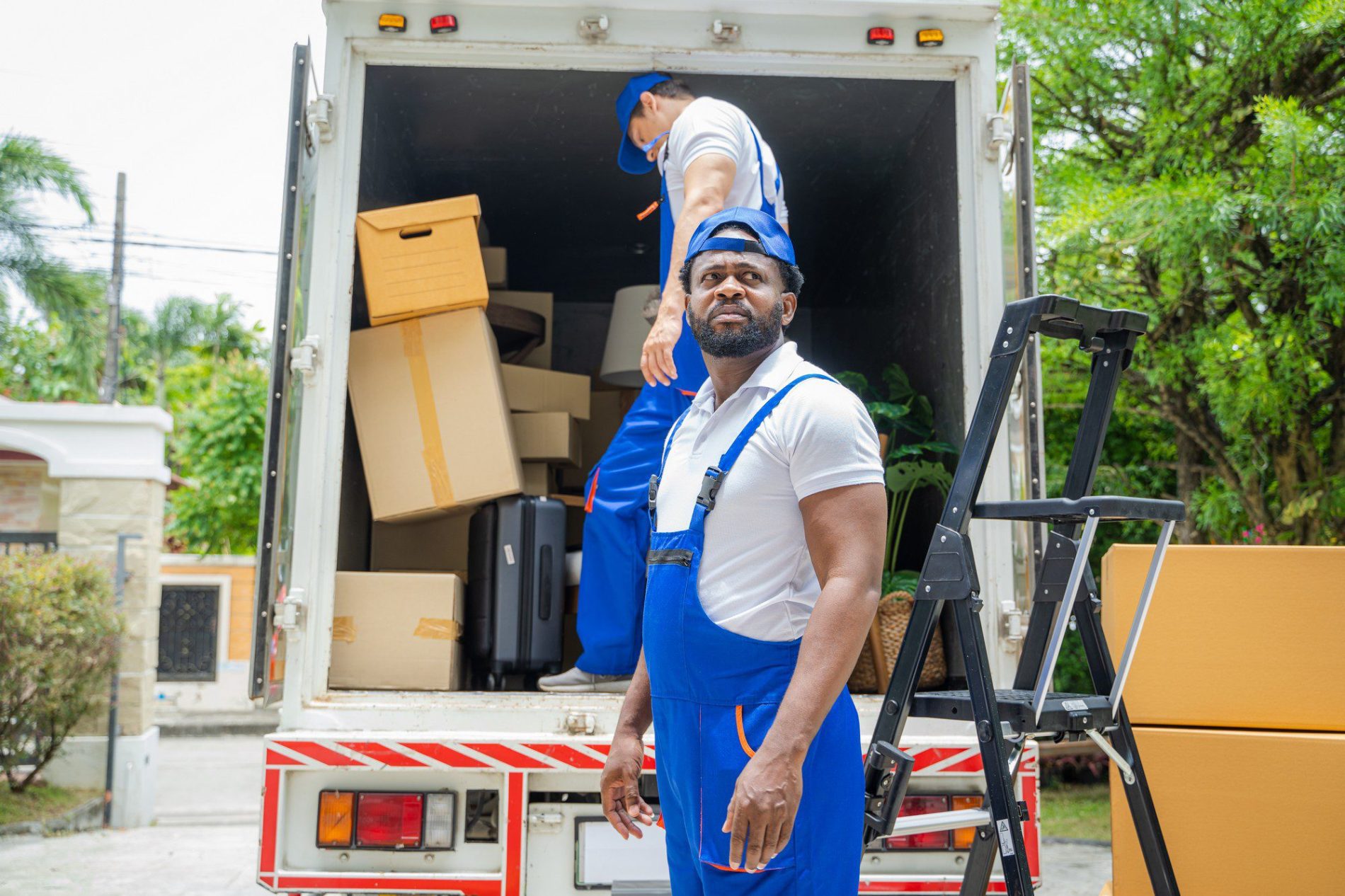 Two Removal Company Workers Are Unloading Boxes Fr 2023 08 18 06 49 52 Utc